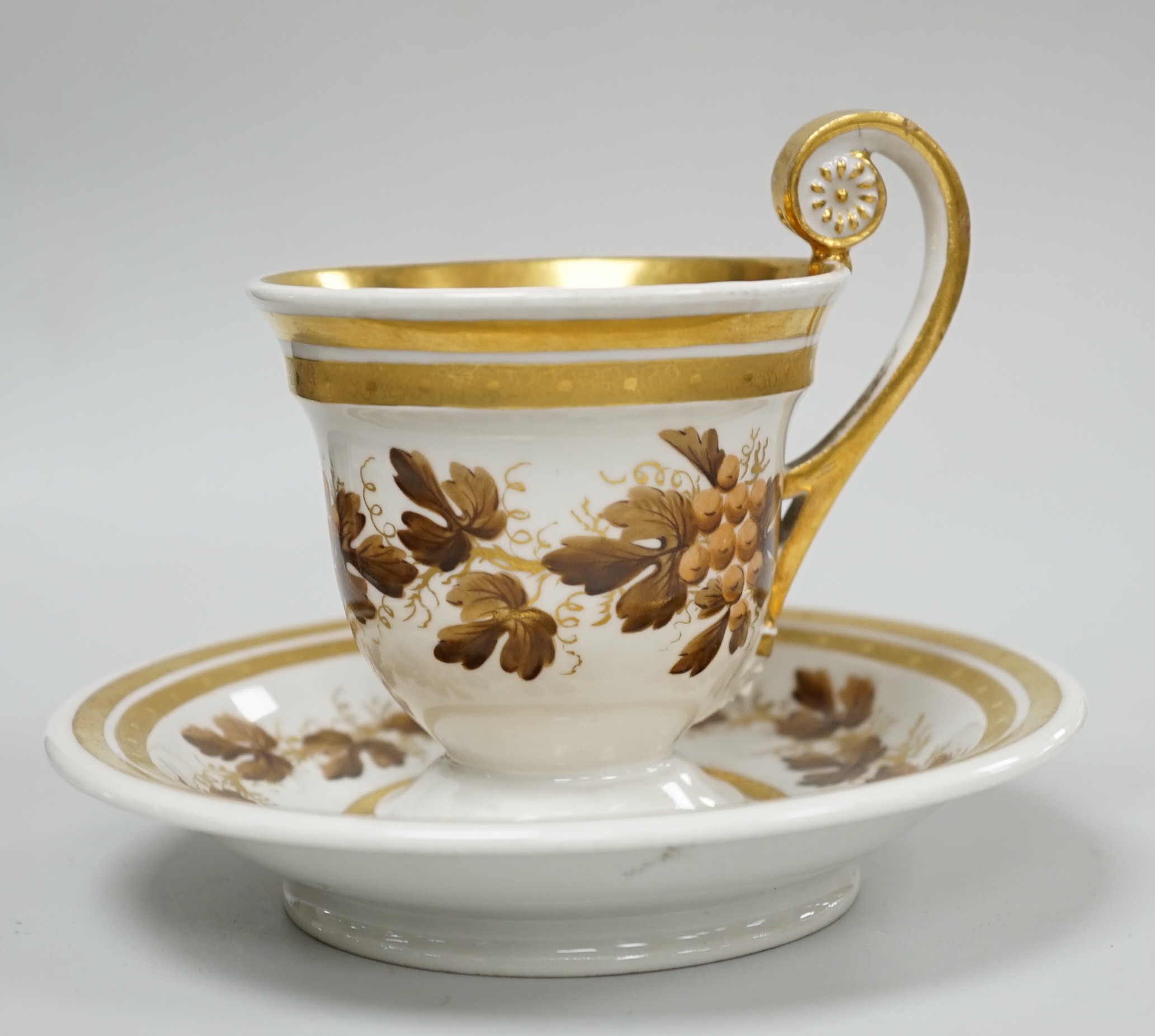 An early 19th century Furstenburg brown and white cup and saucer, saucer diameter 13cm
